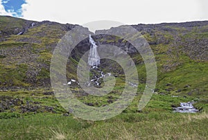 Glumsstadafoss waterfall in fljotsvatn cove in west fjords nature reserve Hornstrandir in Iceland photo