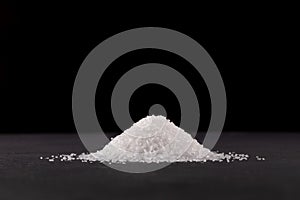 Glutamic acid monosodium salt on dark background. Msg. Food additive E621. Flavor seasoning for enhancing food impressions. The