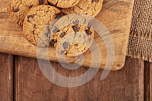 Gluten-free chocolate chip cookies, overhead shot on a dark rustic wooden background