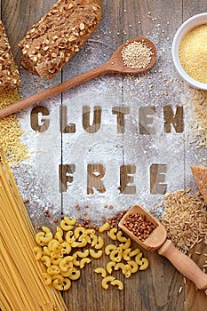 Gluten free flour and cereals millet, quinoa, corn flour polenta, brown buckwheat, basmati rice and pasta with text gluten free in