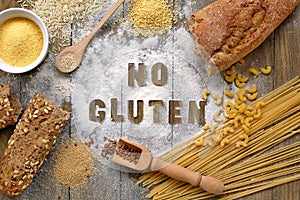 Gluten free flour and cereals millet, quinoa, corn flour polenta, brown buckwheat, basmati rice and pasta with text gluten free in