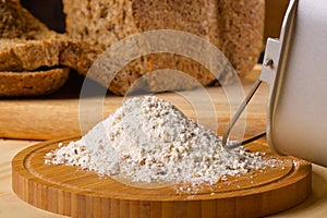 Gluten free flour with cutted fresh bred on wooden