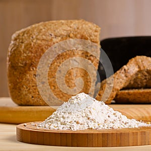 Gluten free flour with cutted fresh bred on wooden