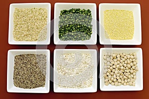 Gluten free grains food - brown rice, millet, LSA, buckwheat flakes and chickpeas and green peas legumes - aerial close-up. photo