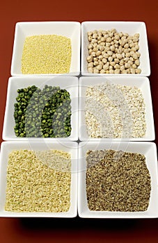 Gluten free grains food - brown rice, millet, LSA, buckwheat flakes and chickpeas and green peas legumes - vertical photo