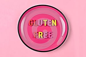 Gluten Free lettering on a pink plate. Nutritional concept.