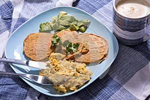 Gluten free pancakes with scrambled eggs and avocado