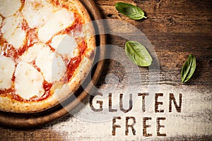 A gluten free pizza on a rustic wood background