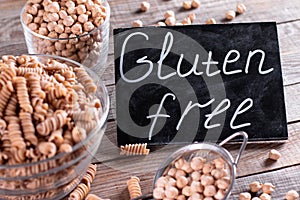 Gluten Free Products. Dried chickpeas and whole wheat pasta in a bowl on the table