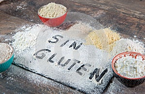 Gluten-free sin gluten flour on wooden background photo