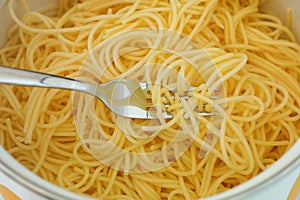 Gluten free spaghetti in a pot with a fork