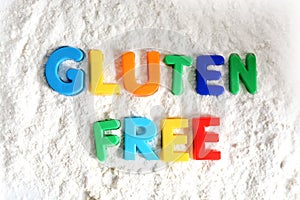 Gluten free text spelled out with colored letters in white flour