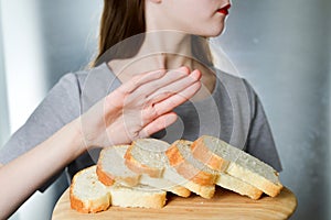 Gluten intolerance concept. Young girl refuses to eat white bread - shallow depth of field