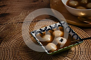 Glutinous rice balls with black sesame in ginger soup, Asian Dessert appetizer.