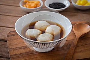 Glutinous rice balls filled with black sesame in sweet ginger soup