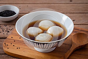 Glutinous rice balls filled with black sesame in sweet ginger soup