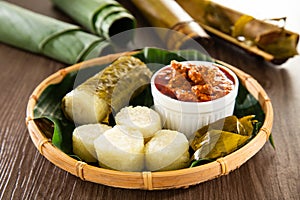 Glutinous rice is wrapped with lerek or banana leaf encased in bamboo culm and cooked in open fire / Lemang / A must have in every