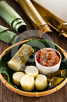 Glutinous rice is wrapped with lerek or banana leaf encased in bamboo culm and cooked in open fire / Lemang / A must have in every