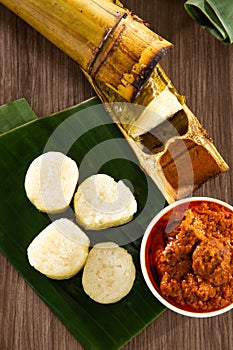 Glutinous rice is wrapped with lerek or banana leaf encased in bamboo culm and cooked in open fire / Lemang / A must have in every