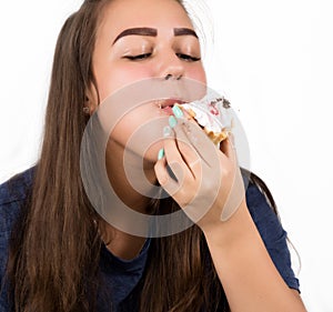 Glutton woman eating cupcakes with frenzy after long diet