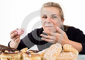 Glutton woman eating cupcakes with frenzy after long diet