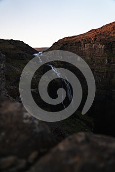 Glymur waterfall during sunset in summer