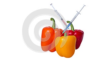 GMO food concept. Syringes are stuck in vegetables with chemical additives. Injections into fruits and vegetables.