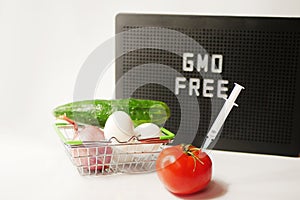 GMO free food. Organic products. Syringe in tomato