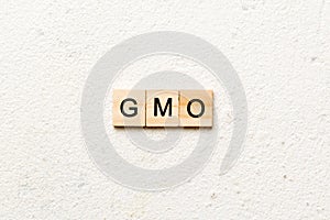 gmo word written on wood block. gmo text on table, concept