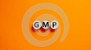GMP, good manufacturing practice symbol. Concept words GMP, good manufacturing practice on circles on a beautiful orange