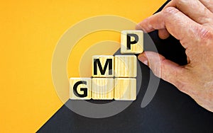 GMP, good manufacturing practice symbol. Concept words GMP, good manufacturing practice on cubes on a beautiful yellow background