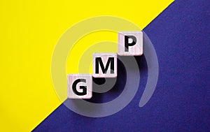 GMP, good manufacturing practice symbol. Concept words `GMP, good manufacturing practice` on cubes on a beautiful yellow and bla