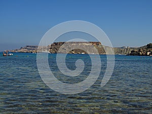 GNEJNA BAY, MGARR, MALTA - Jul 20, 2014: Photo of the calm blue sea at GnejnaBay, Mgarr Malta, with Qarraba promontory headland in