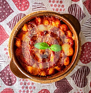 Gnocchi alla Sorrentina, Italian Potato Dumplings in Tomato Sauce, Gratinated With Mozzarella Cheese in a Terracotta Dish