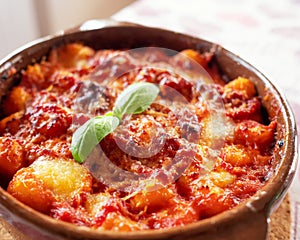 Gnocchi alla Sorrentina, Italian Potato Dumplings in Tomato Sauce, Gratinated With Mozzarella Cheese in a Terracotta Dish