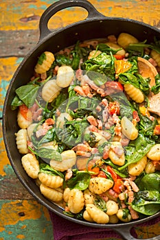 Gnocchi with bacon, spinach & tomatoes photo