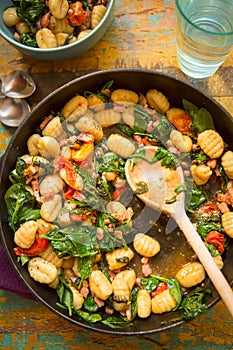 Gnocchi with bacon, spinach & tomatoes photo