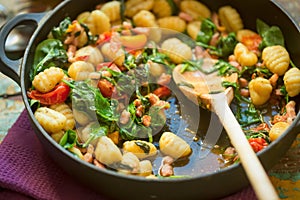 Gnocchi with bacon, spinach & tomatoes photo