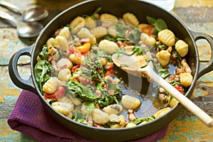 Gnocchi with bacon, spinach & tomatoes photo