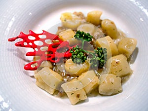 Gnocchi pasta with herbs dish closeup