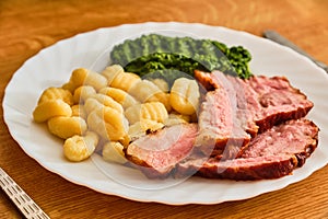 Gnocchi with smoked meat and spinach