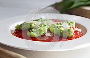 Gnocchi with wild garlic in tomato sauce and parmesan cheese