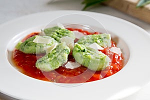 Gnocchi with wild garlic in tomato sauce and parmesan cheese