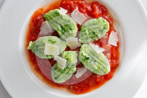 Gnocchi with wild garlic in tomato sauce and parmesan cheese