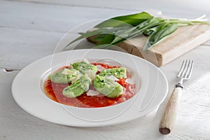 Gnocchi with wild garlic in tomato sauce and parmesan cheese