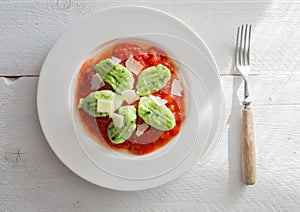 Gnocchi with wild garlic in tomato sauce and parmesan cheese