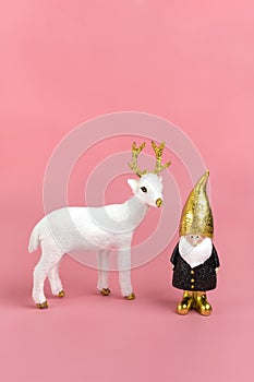 Gnome, deer in black, white, golden color on pink background Happy New Year, Merry Christmas concept Holiday card