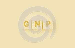 GNP Gross Domestic Product word made with wooden blocks on yellow background