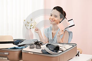 Go on an adventure! Happy woman preparing for the journey. Young person with suitcases