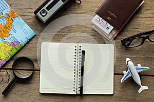 Go on an adventure! The map and the passport on a wooden table.